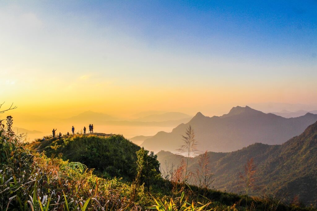 Photo of people standing on top of mountain near grasses 733162 jpg
